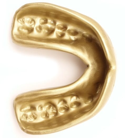 Gold athletic mouthguard with teeth marks visible